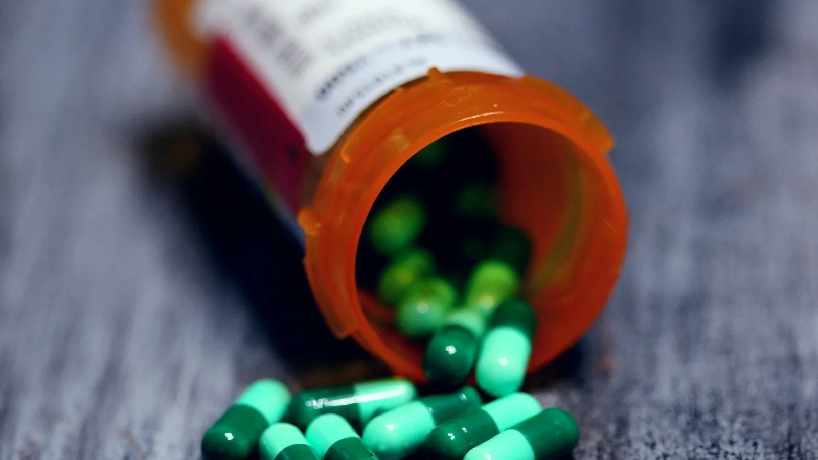 Prescription bottle with capsules on a table