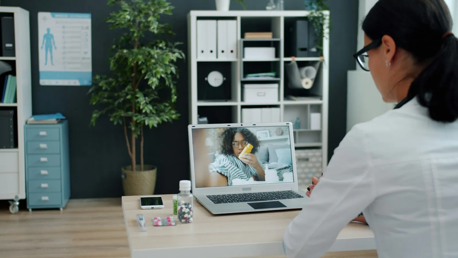 Clinician conducting a telehealth video visit on a laptop