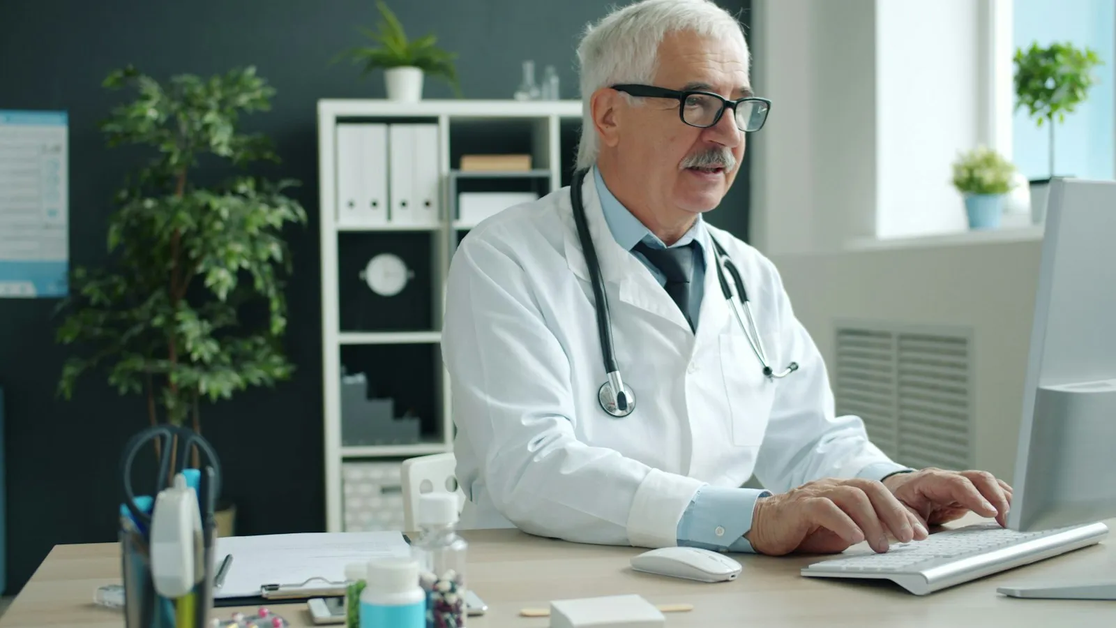 Clinician working at a computer in a clinic office
