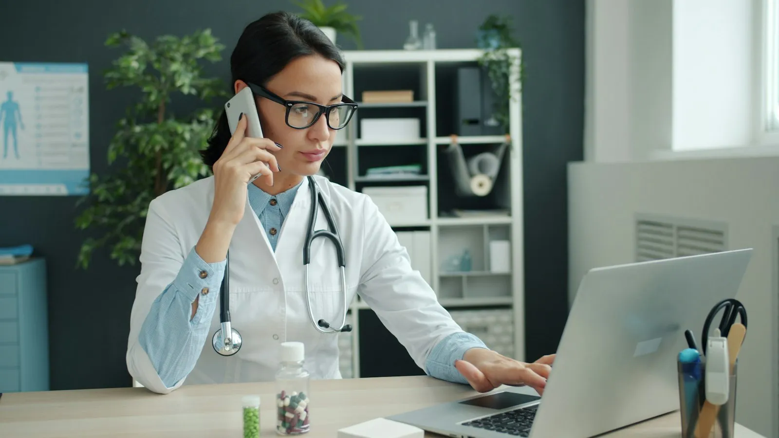 Clinician working on a laptop in her office while comparing ADHD assessment tools